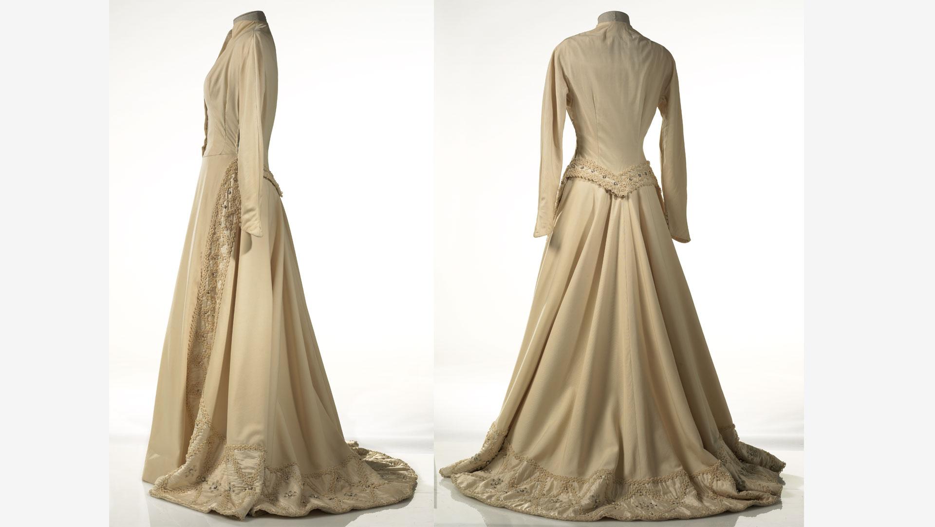 The House of Carosa wedding gown (1952) is made from a heavy wool gabardine, and features silk panels embellished with pearls, semi-precious stones and cord. Collection of Te Papa.