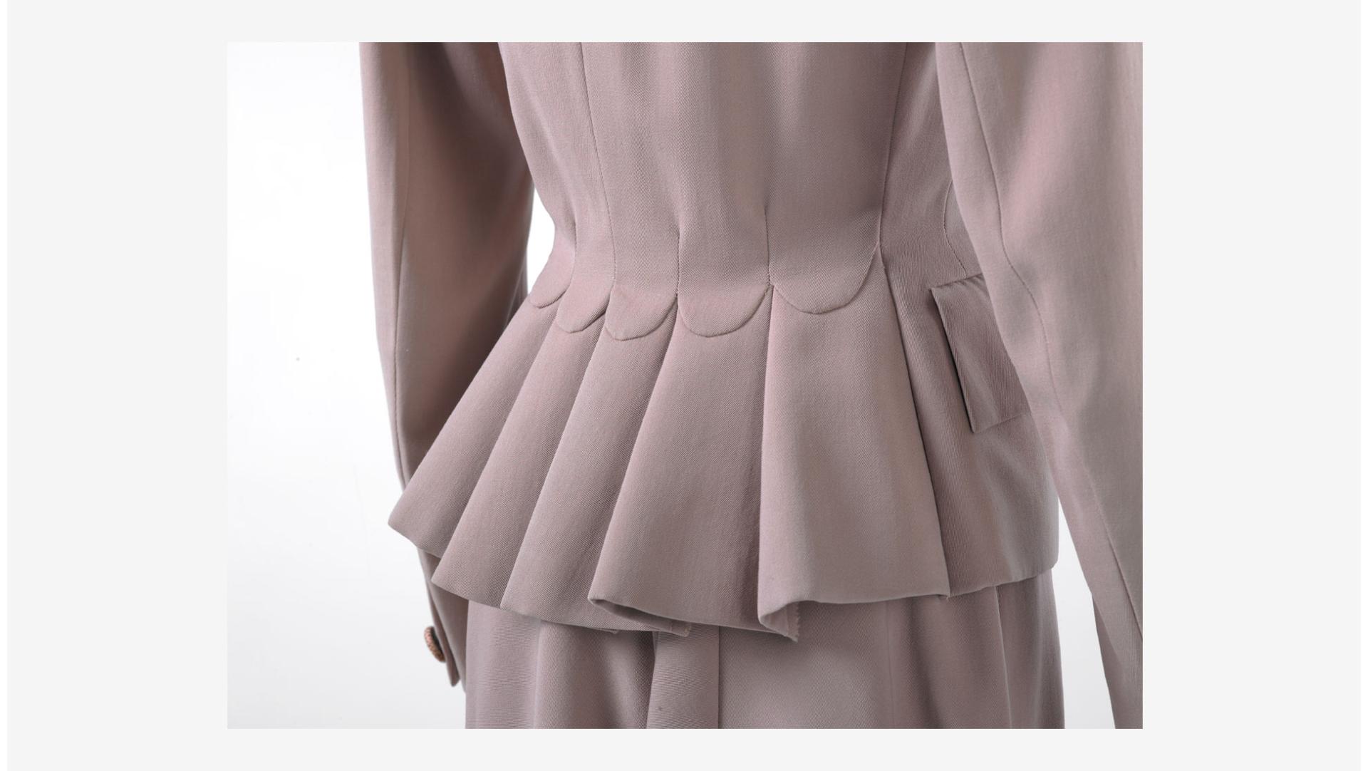 Detail of the Hardy Aimes pale pink woollen suit. Collection of Te Papa.