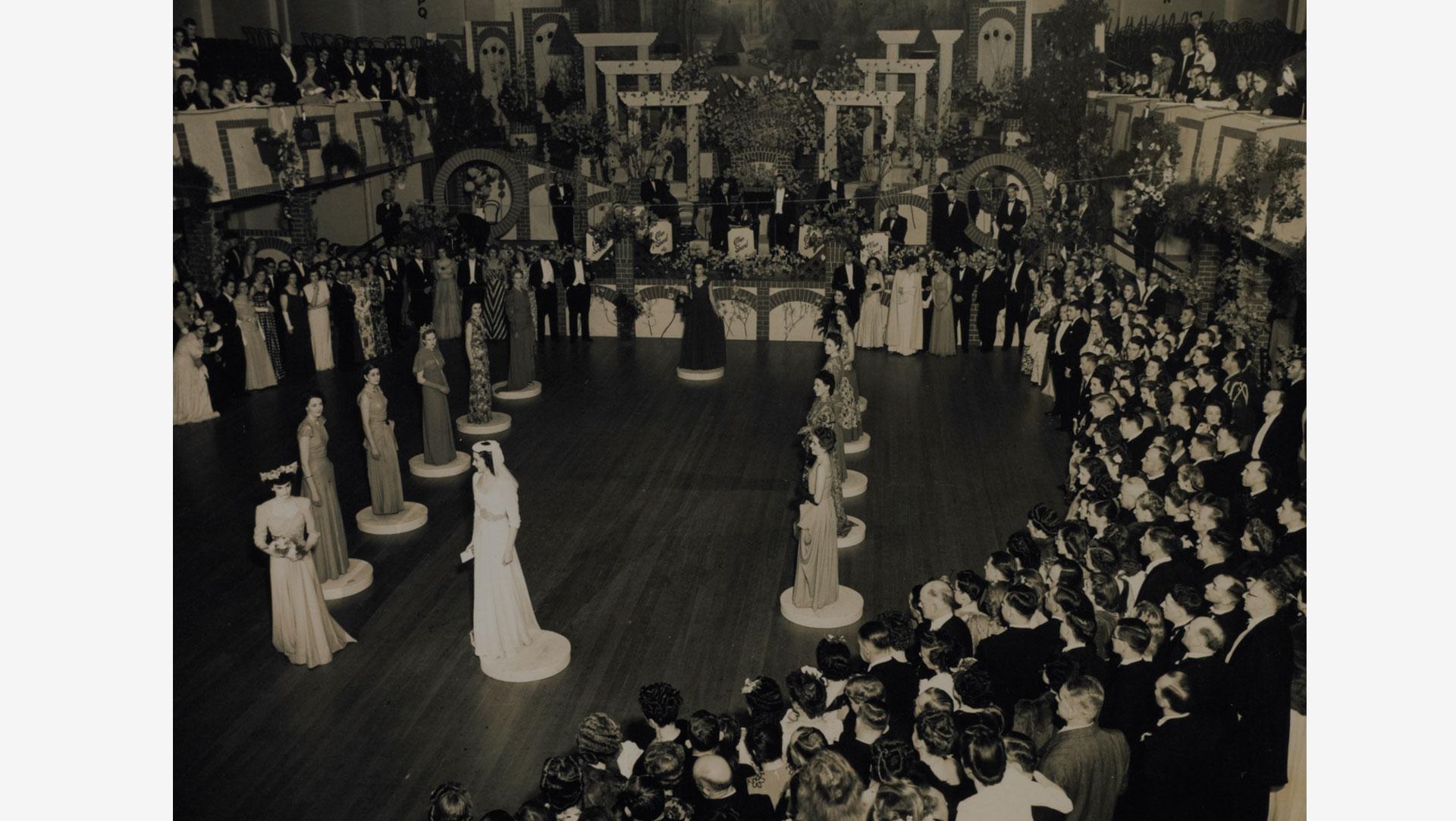 'Wool After Dark' was held in association with the 1948 Plunket Society Ball in Wellington. The show concluded with a wedding gown designed by Peter Robb of Australia (centre). Collection of Te Papa.